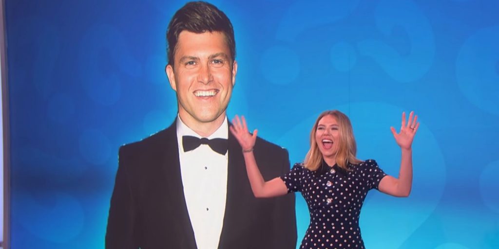 Scarlett Johansson in The Ellen Show, behind her there's a picture of her fiance, Colin Jost