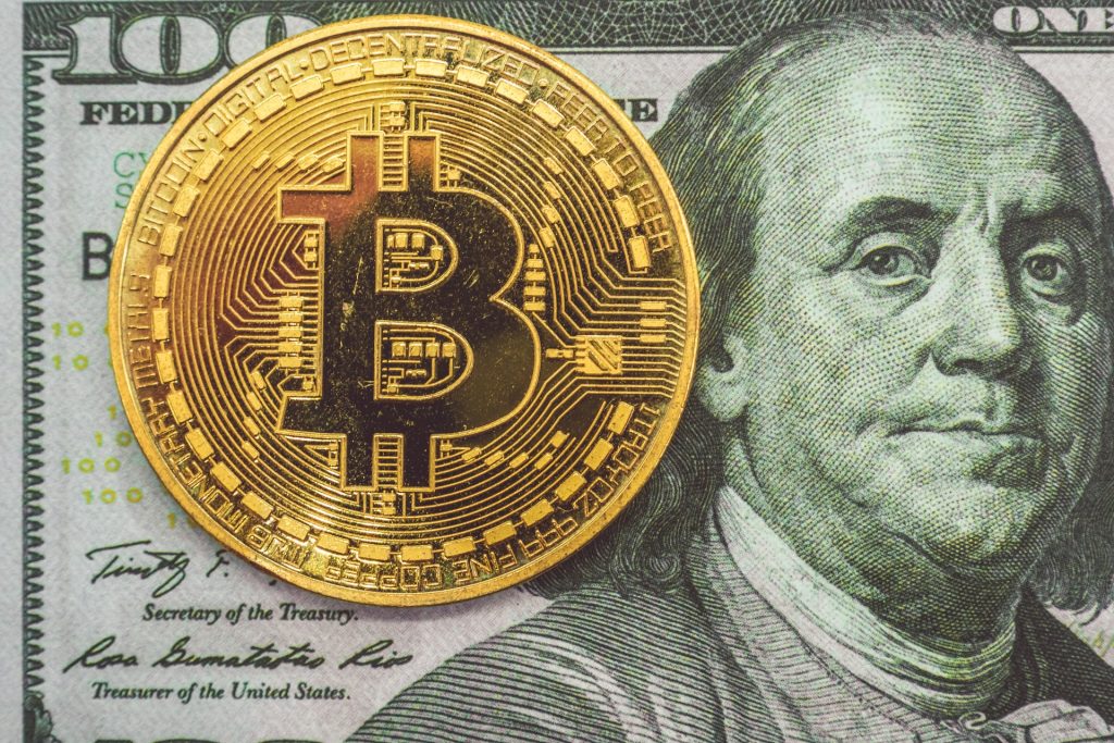 An image of bitcoin and USD currency note