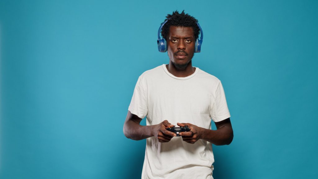 young person holding gaming headphones